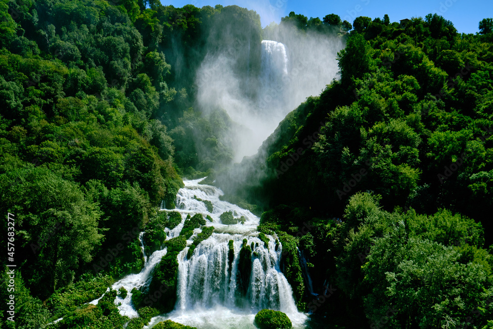 Marmore waterfalls from Pennarossa inferiore view. Water nebulization in Umbria near Terni. Italian magic fairy waterfall made by ancient Roman in sunny summer day