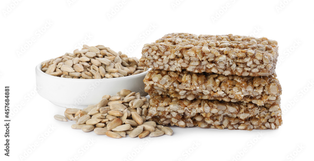 Delicious sweet kozinaki bars and sunflower seeds on white background Delicious sweet kozinaki bars and sunflower seeds on white background