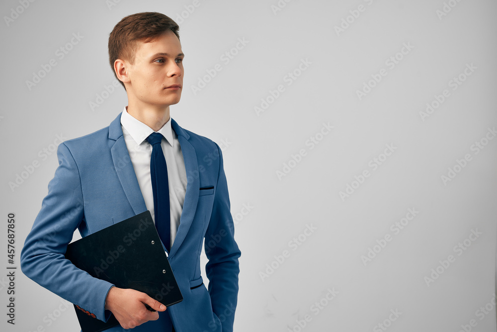 handsome business man in a suit with documents in the hands of studio manager handsome business man in a suit with documents in the hands of studio manager
