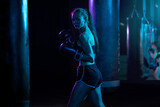 Boxing. Sport concept. Girl sportsman muay thai boxer fighting in gloves in gym.