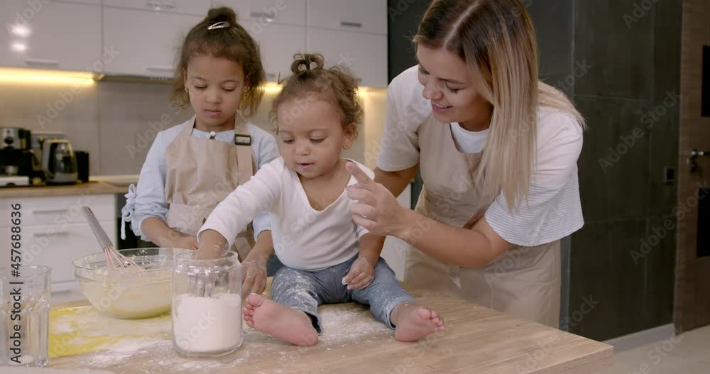 Mother with kids at the kitchen cooking Mother with kids at the kitchen cooking