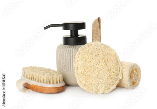 Set of toiletries with natural loofah sponges on white background