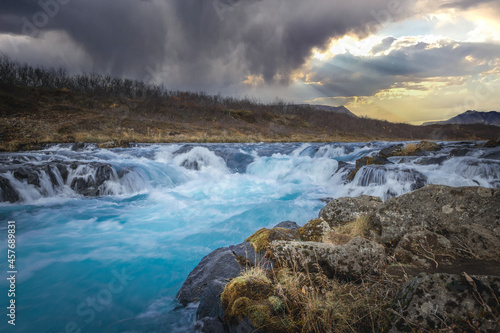 Colorful sunset at the Bruarfoss waterfall in south Iceland with blue water