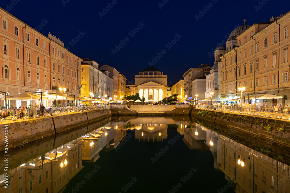 Canal Grande di Trieste at night with beautiful buildigs and refletion on the water