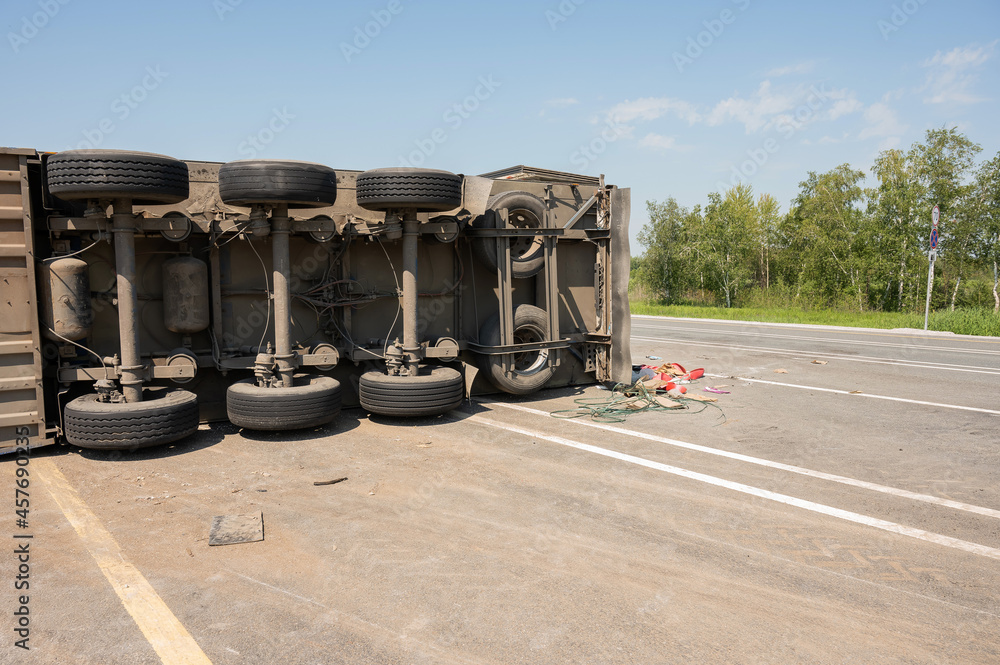 The truck is lying on its side in a car accident on the highway Stock ...