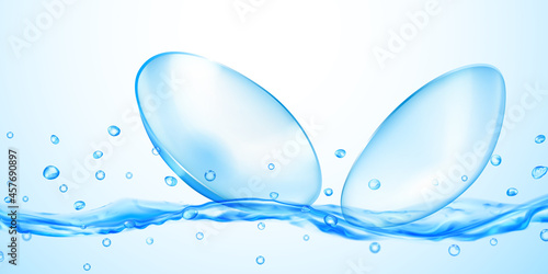 Realistic translucent contact lenses in light blue color with water flow, splash and drops