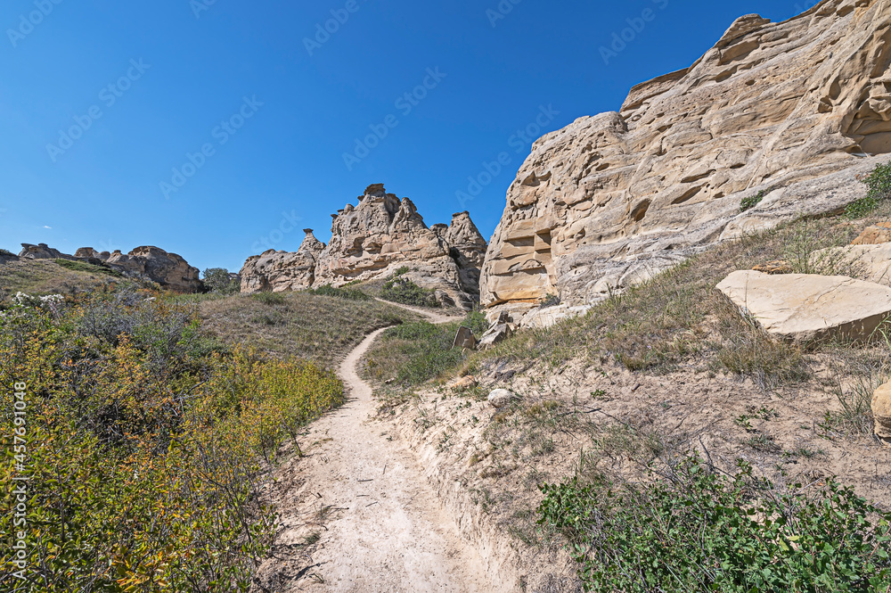 Path leading to eroded rock in Writing on Stone Provincial Park, Alberta, Canada