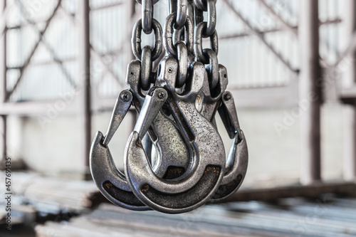 Photography Lifting mechanism iron chain with a hook of an overhead crane on the background of an industrial enterprise or factory