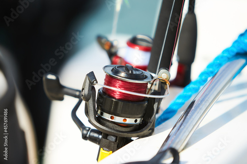 Fishing rods with reels on the boat in natural setting