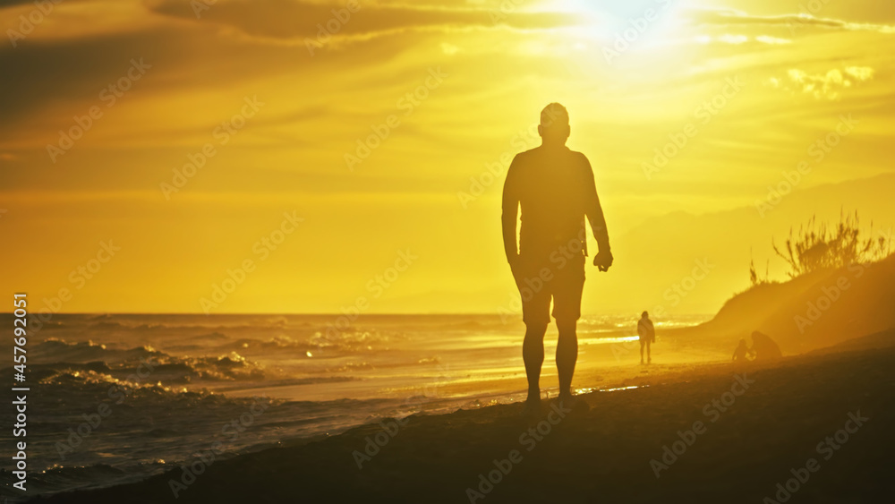 Backlit people at the beach on a windy day Backlit people at the beach on a windy day