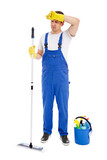 full length portrait of tired man cleaner in blue uniform cleaning floor with mop isolated on white background