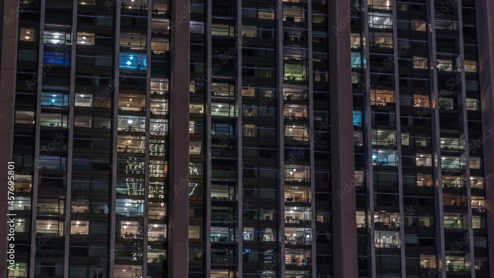 Big glowing windows in modern office and residential buildings timelapse at night Big glowing windows in modern office and residential buildings timelapse at night