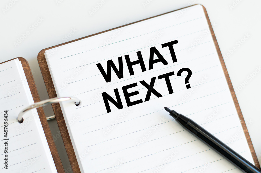 What's next text on notepad beside black marker