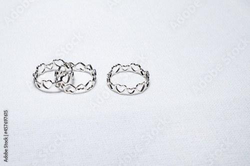 Heart rings on white cloth background