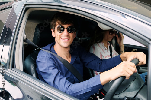 Smiling Young Caucasian traveler couple love is relaxing and Driving a car for travel on holiday. Happiness of Honeymoon trip on vacation concept © cocorattanakorn