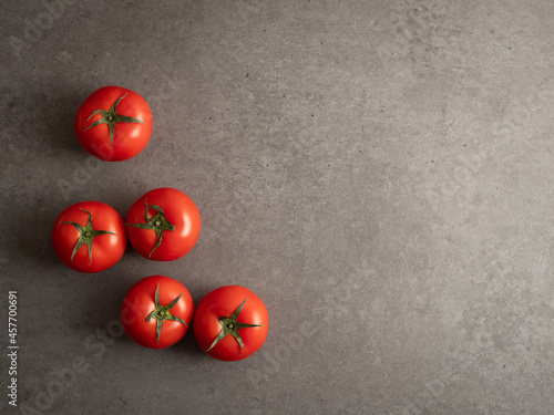 Fresh tomatoes on marble background 
