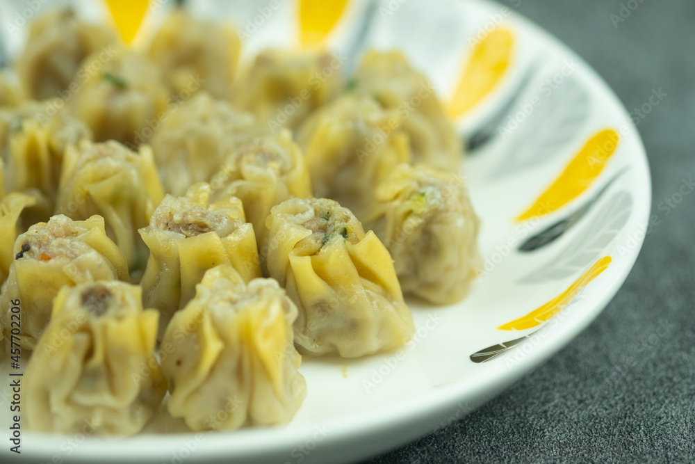 Mini pork Dim Sum on a white dish Mini pork Dim Sum on a white dish