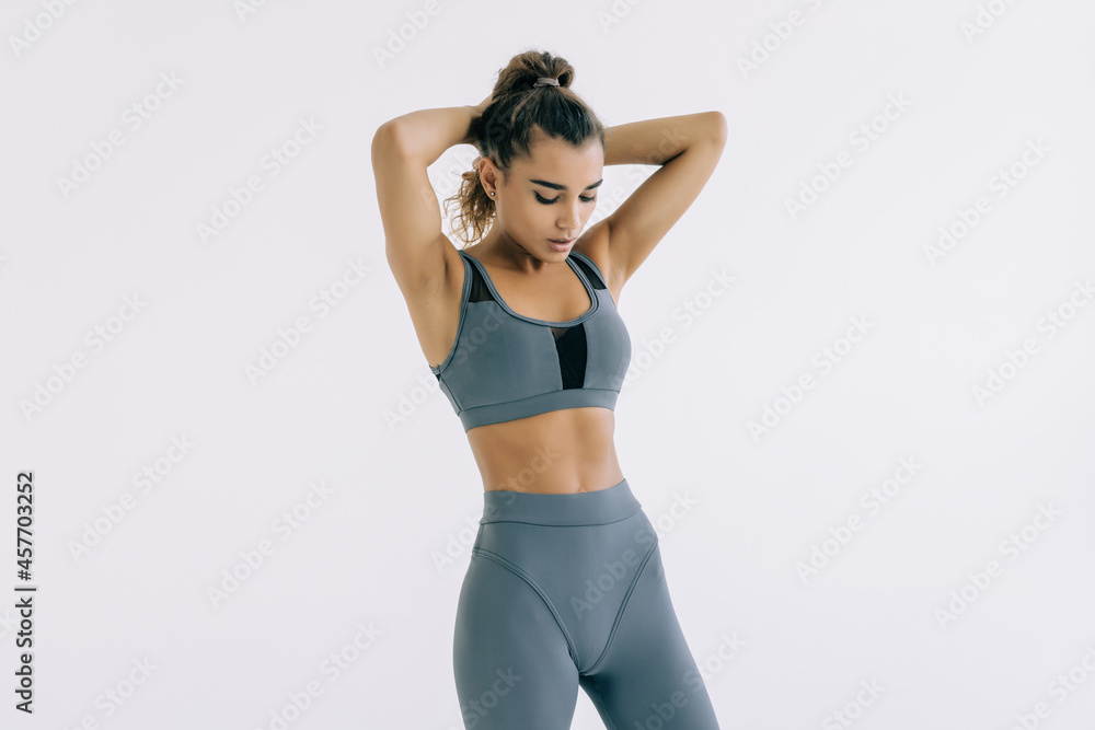 Fototapeta premium Young woman in sportswear on white background