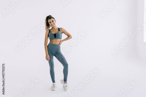 fitness woman in sport style standing against white background. © F8  \ Suport Ukraine