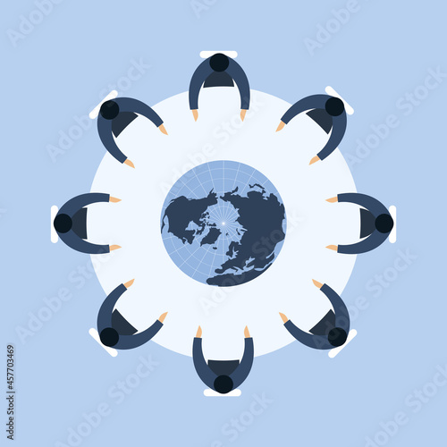 People are sitting around a round table with a globe in the centre