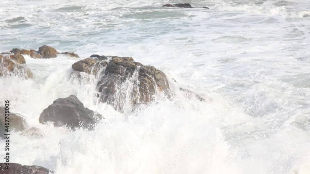 Powerful waves of the sea foaming, breaking against the rocky shore. Powerful waves of the sea foaming, breaking against the rocky shore.
