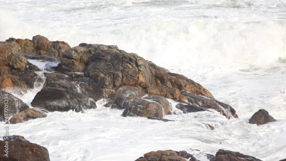 Powerful waves of the sea foaming, breaking against the rocky shore. Powerful waves of the sea foaming, breaking against the rocky shore.