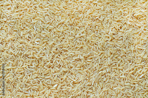 Top view of dry organic brown rice background for clean food ingredient or agricultural product concept