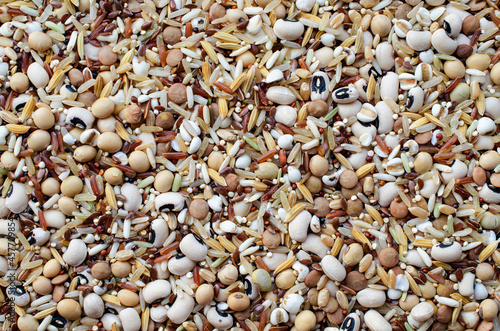 Mixed dry organic cereal and grain seeds pile on white background, for healthy or clean food ingredient or agricultural product concept