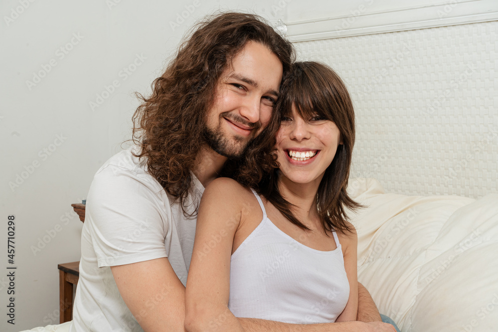 Portrait of a happy couple laughing at camera Portrait of a happy couple laughing at camera