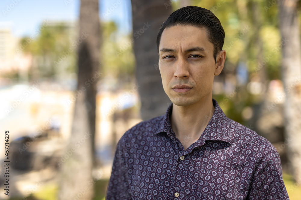 Asian man at Waikiki beach in Hawaii portrait serious face Asian man at Waikiki beach in Hawaii portrait serious face