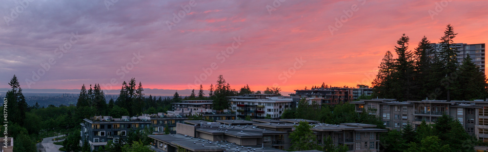 Sunset panorama at Univercity Highlands residential community on Burnaby Mountain, BC with views to distant Straits of Georgia and Burrard Inlet