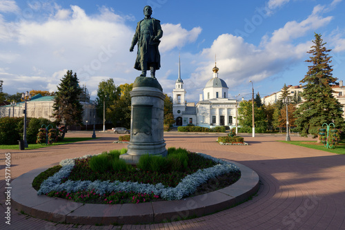Beautiful city Tver landscape view of monument to Afanasy Nikitin on river Volga embankment with Resurrection church and sky, trees and russian buildings. Small city architecture concept. Tver, Russia