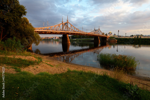 Beautiful city Tver landscape view of starovolzhsky bridge on river Volga embankment with tree,  garden palace, dramatic sunset sky and russian buildings. Small city architecture concept. Tver, Russia