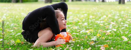 Girl gymnast in the park goes in for sports. Photo series. Banner