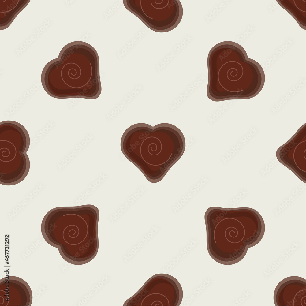 Fototapeta premium A pattern of chocolate hearts on a beige background