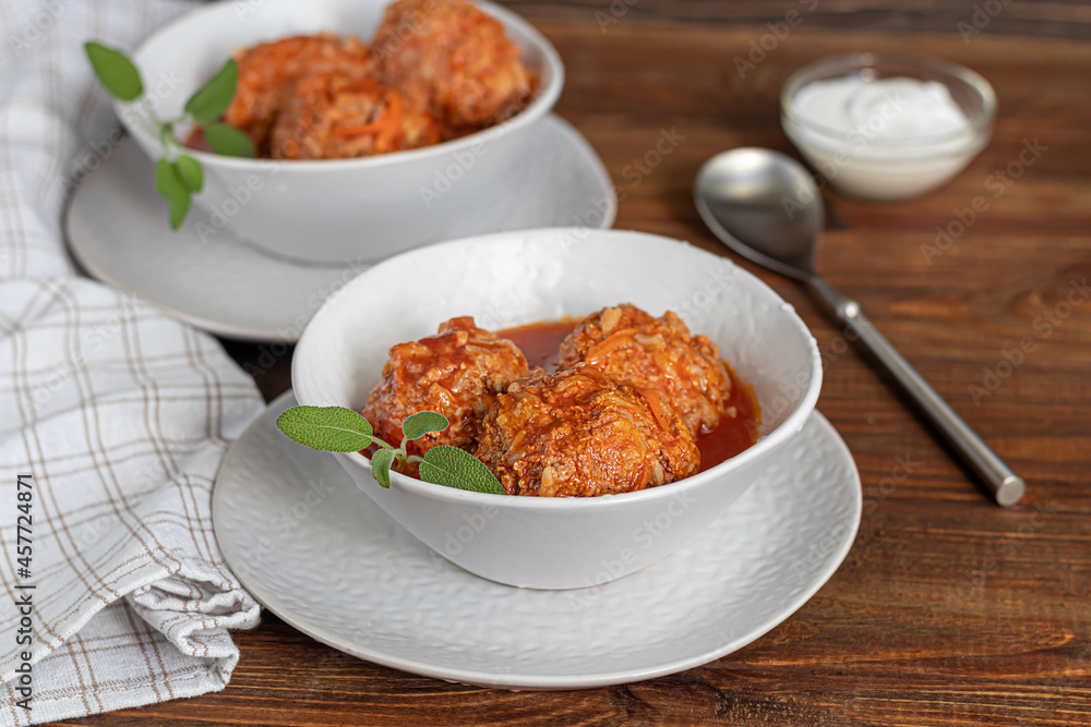 Meat balls on a wooden background with sage and parsley leaves. Homemade lunch. Meat balls on a wooden background with sage and parsley leaves. Homemade lunch.