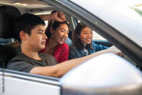 Happy Asian friends drive car for road trip © Blanscape