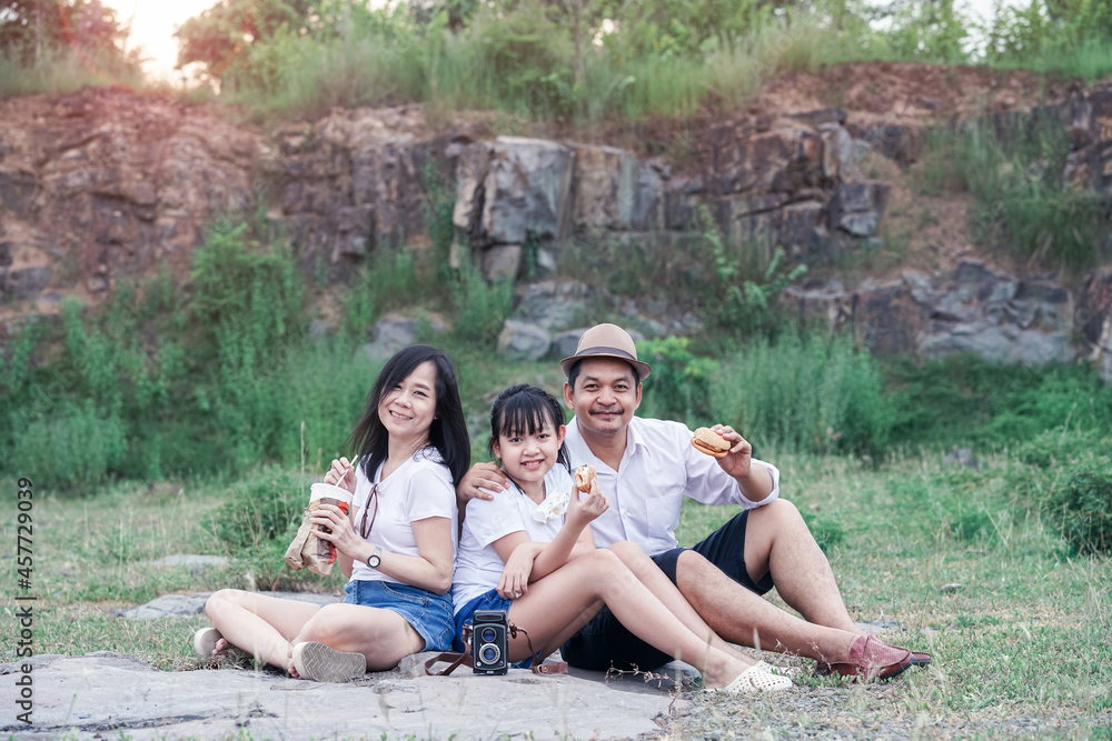 Family picnicking in the midst of nature with the cliff of background Family picnicking in the midst of nature with the cliff of background