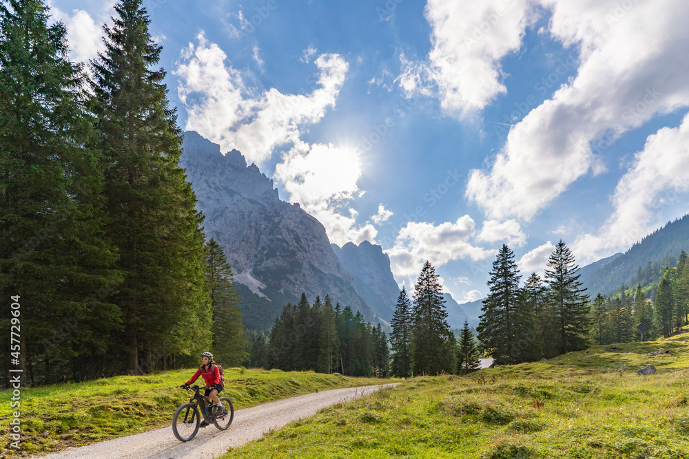 beautiful active senior woman with electric mountainbike in the spectacular Mountains of Raintal Valley, a side valley of Lechtal, Tyrol, Austria