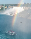 Boat in front of Niagara Falls with the rainbow in Ontario Canada