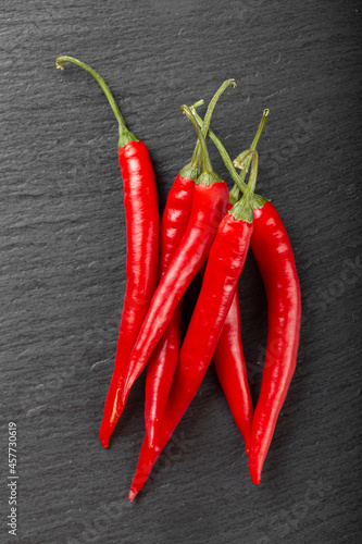 Pods of red chili peppers on a dark background