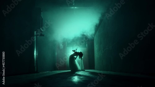 Dead zombie woman scaring in dark corridor. Creepy bride wearing wedding dress with veil. Deceased fiancee returned to life. Horrible klip for halloween, traditional usa holiday. Haunted house. 