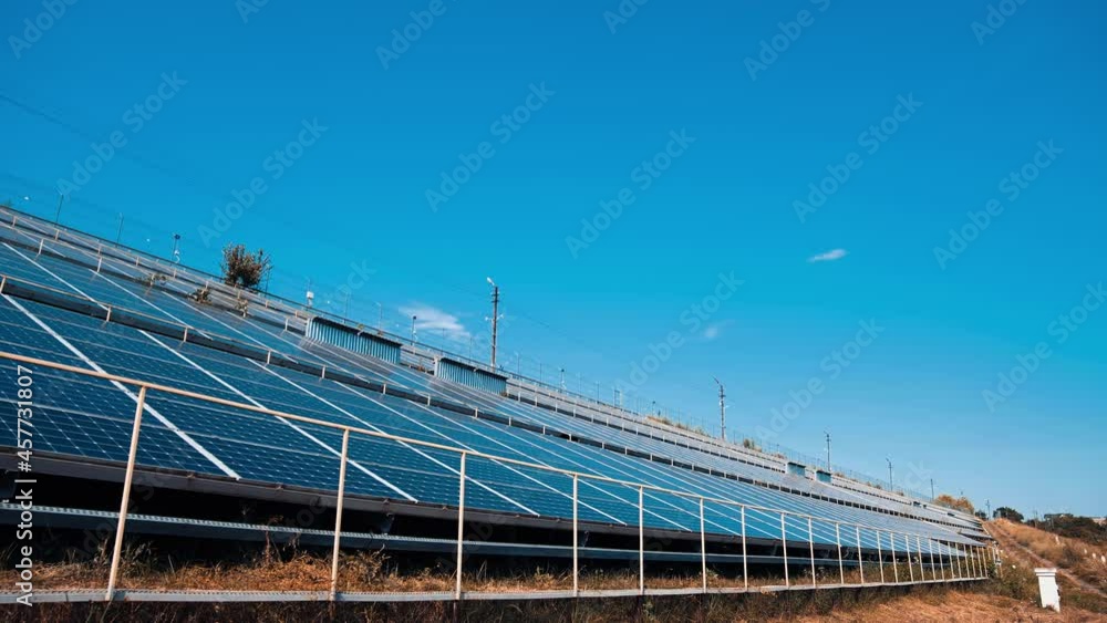 New solar farm near the road. Photovoltaic panels receive ecological energy from the sun. Sustainable source of clean energy. New solar farm near the road. Photovoltaic panels receive ecological energy from the sun. Sustainable source of clean energy.