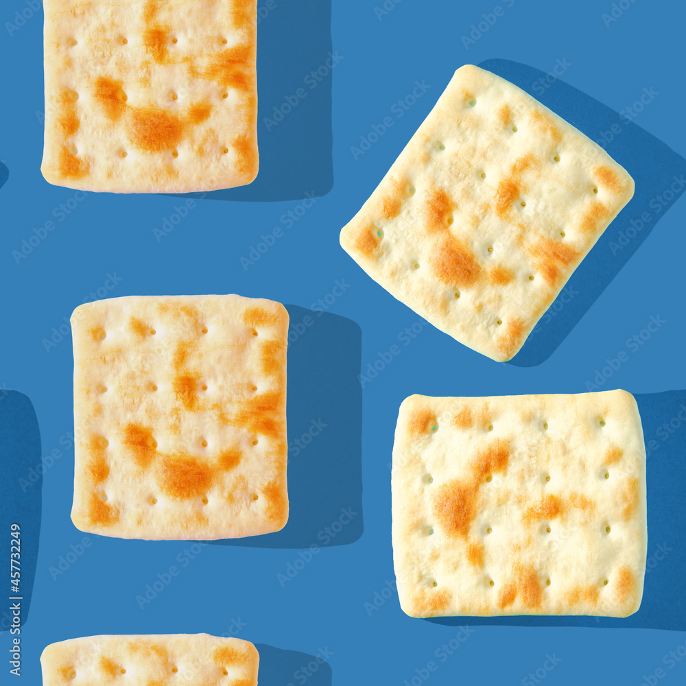 Photo in the form of a seamless pattern. Yellow-brown biscuits with shadows on a colored blue background. High quality photo