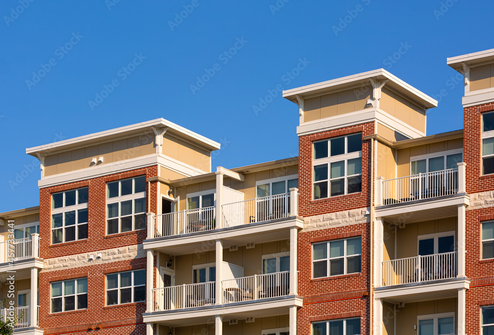 Generic apartment building exterior with blue sky; copy space Generic apartment building exterior with blue sky; copy space