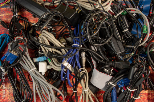 Disused stack of old computer cables and devices