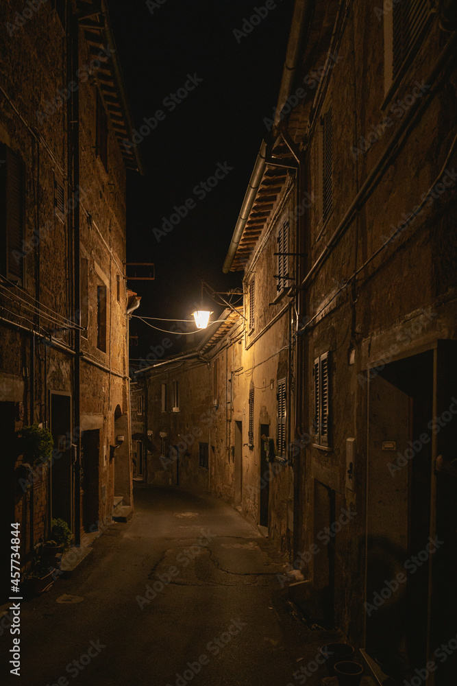 old mediterranean alley at night in acquapendente, italy