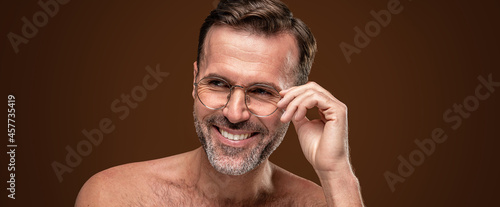 Beauty portrait of handsome man wearing eyeglasses with a toothy smile on his face photo