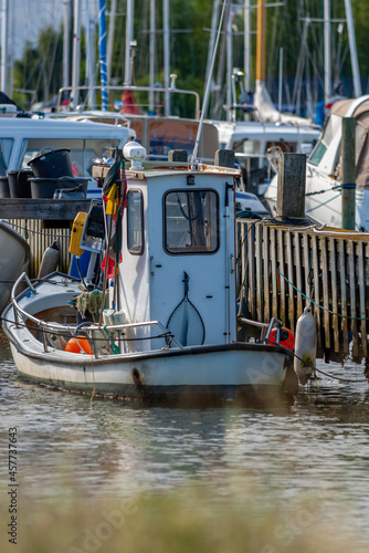 Old fishing cutter, with small wheelhouse, and low freeboard photo