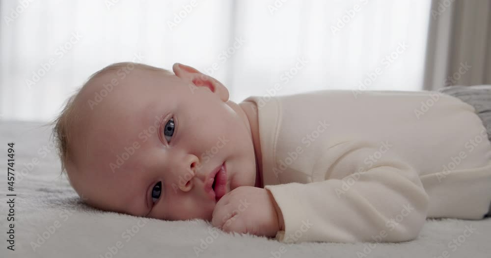 A small healthy baby being active in the morning. Cute infant being energetic on a sunny day. Baby stare. Beautiful caucasian baby at home stareing into camera. A small healthy baby being active in the morning. Cute infant being energetic on a sunny day. Baby stare. Beautiful caucasian baby at home stareing into camera.